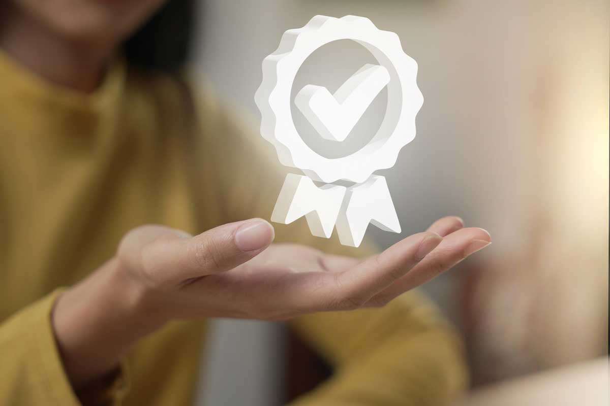 Quality assurance symbol hovers above a hand