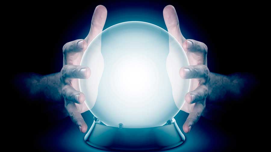Hands hold a glowing crystal ball