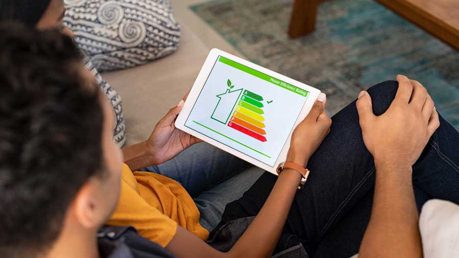 Couple look at house efficiency rating on a tablet