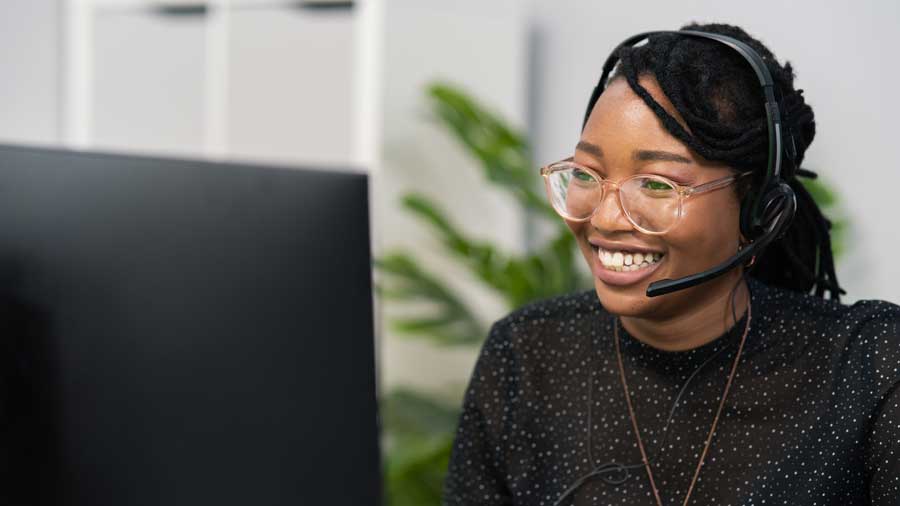 Female employee talks to customer on headset