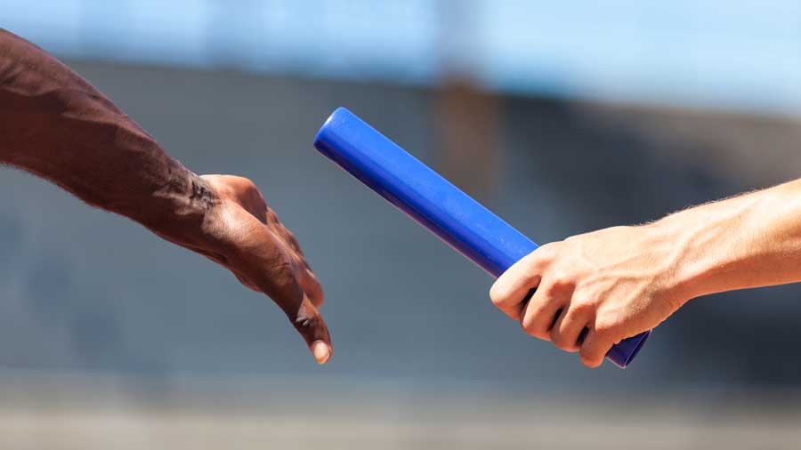 Sprinters passing the relay baton