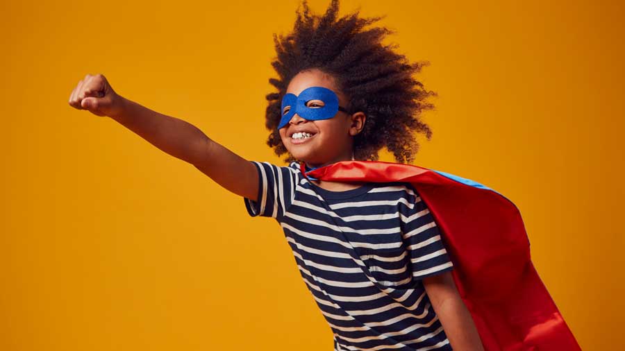 A boy dressed as a superhero