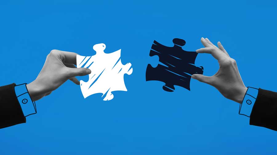 Hands connecting puzzle pieces