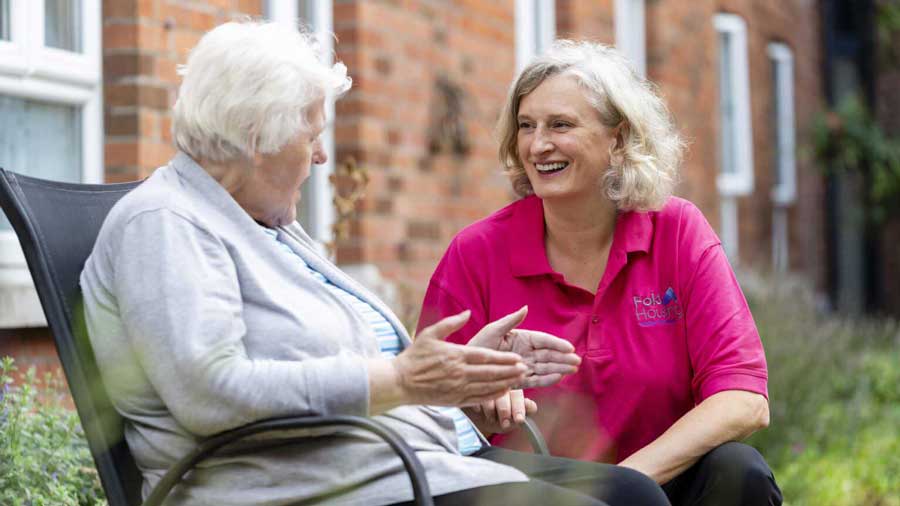 A Fold Housing employee talks to an elderly resident