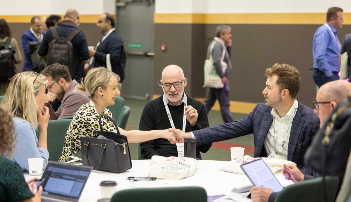 Delegates shake hands at the ISHF conference