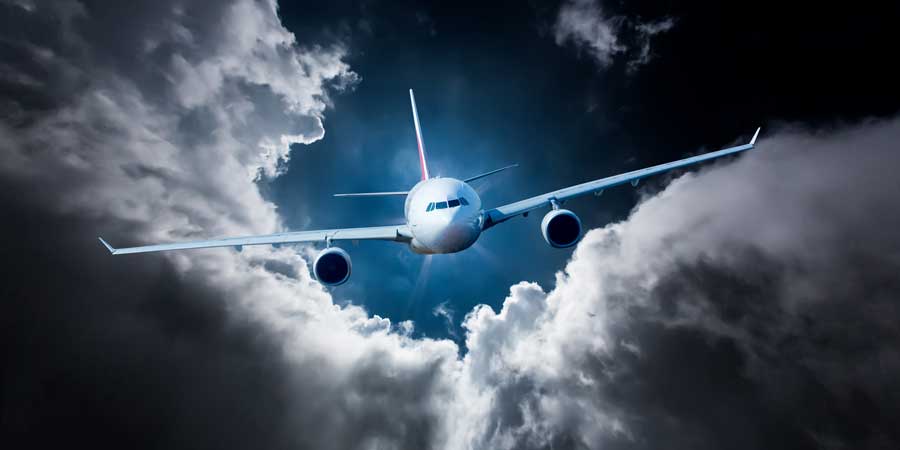A plane flies through stormy skies