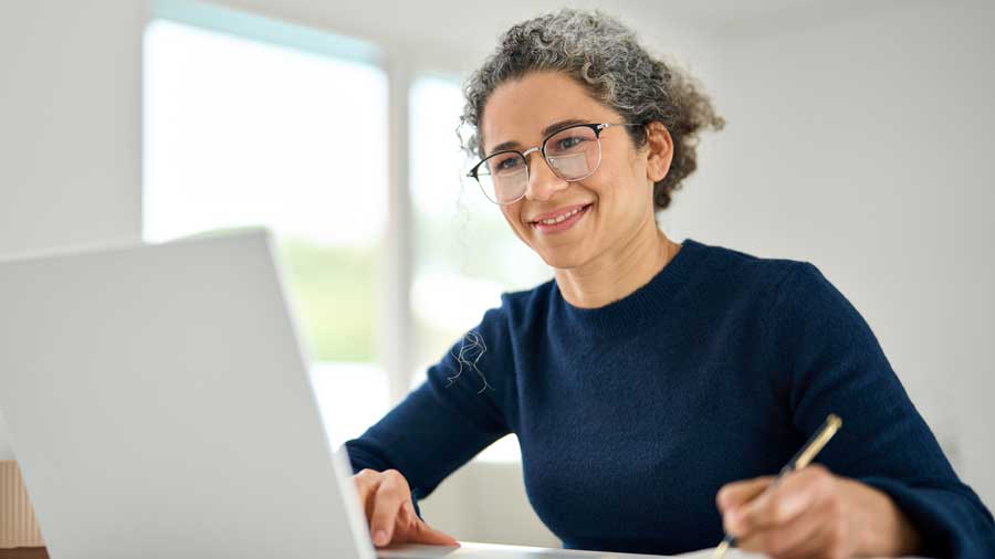 An older woman studies online