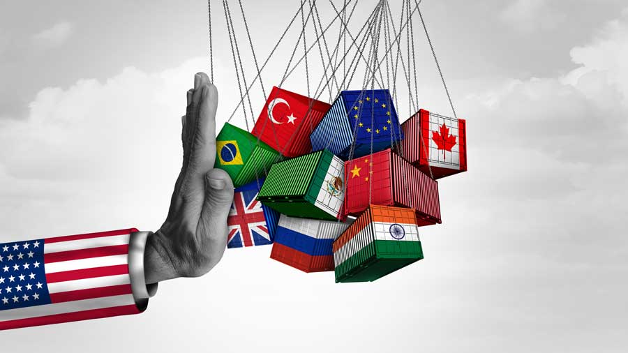 An arm covered in the US flag blocking trade with other countries