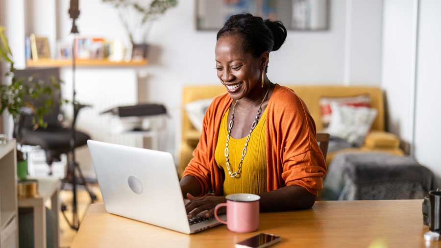 A woman works at home on her laptop