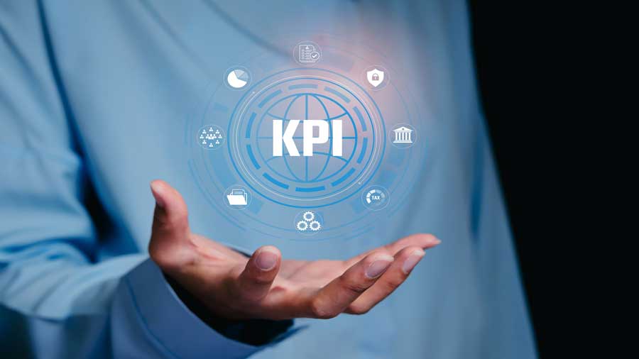 A woman holds a graphic with digital icons representing key performance indicators