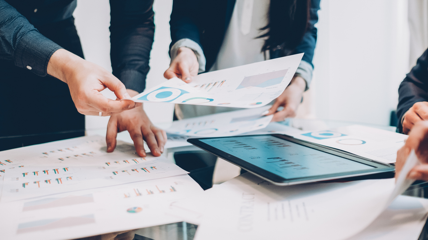 arketing analysis. Cropped shot of business partners working on project, reviewing graphs and diagrams.