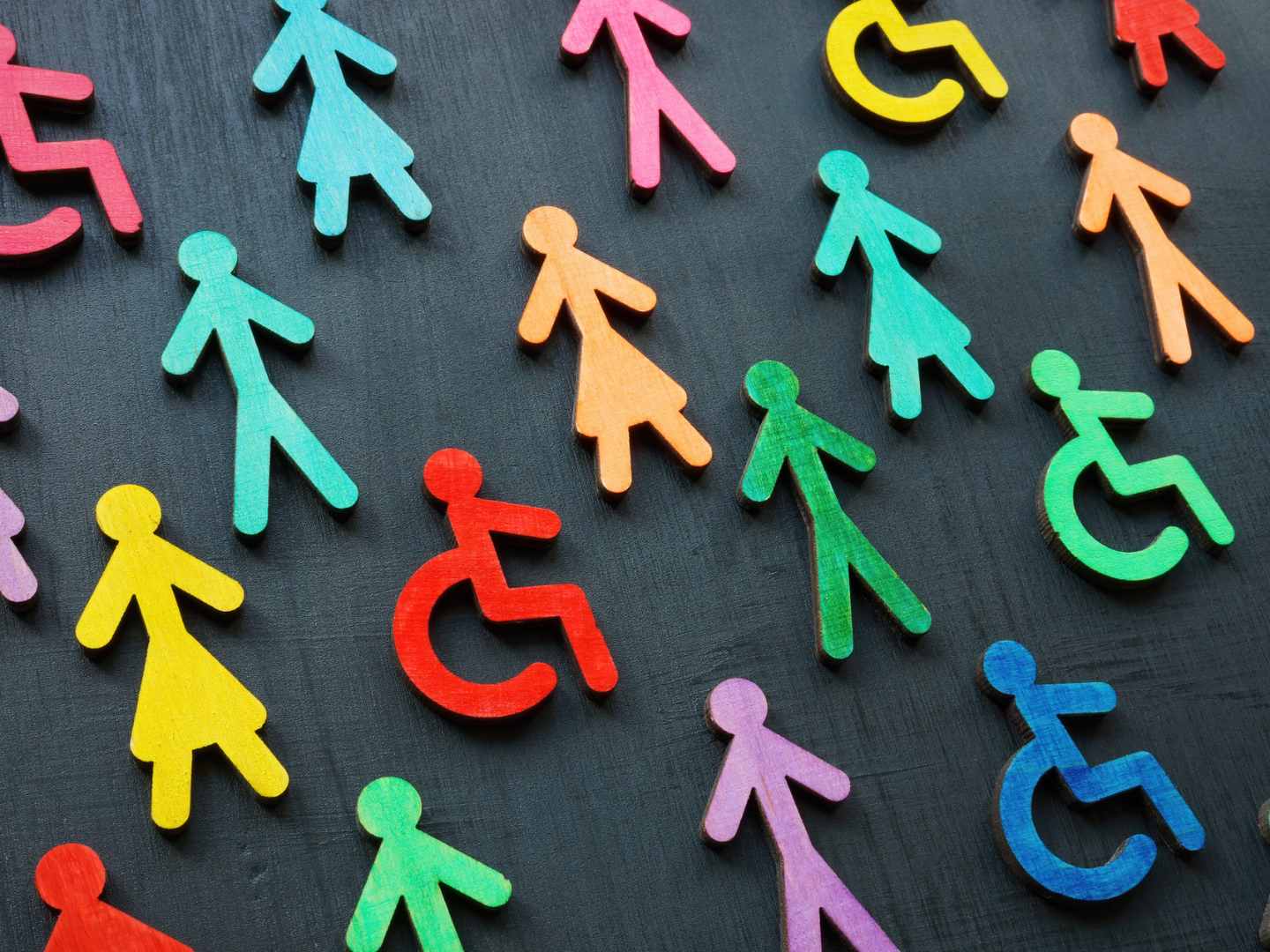 Colourful figurines on the dark surface. Diversity and inclusion concept