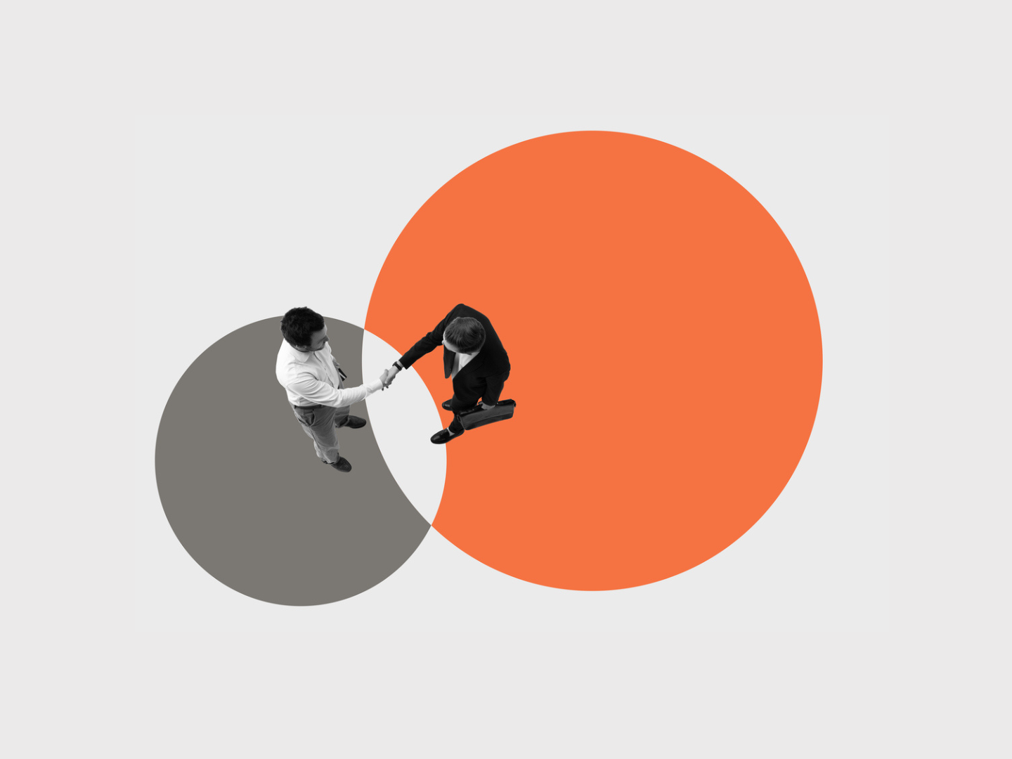 Conceptual artwork of businessmen shaking hands in intersecting circles symbolizing merger integration stock photo