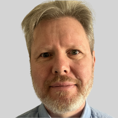 Headshot of a man in a pale blue shirt.